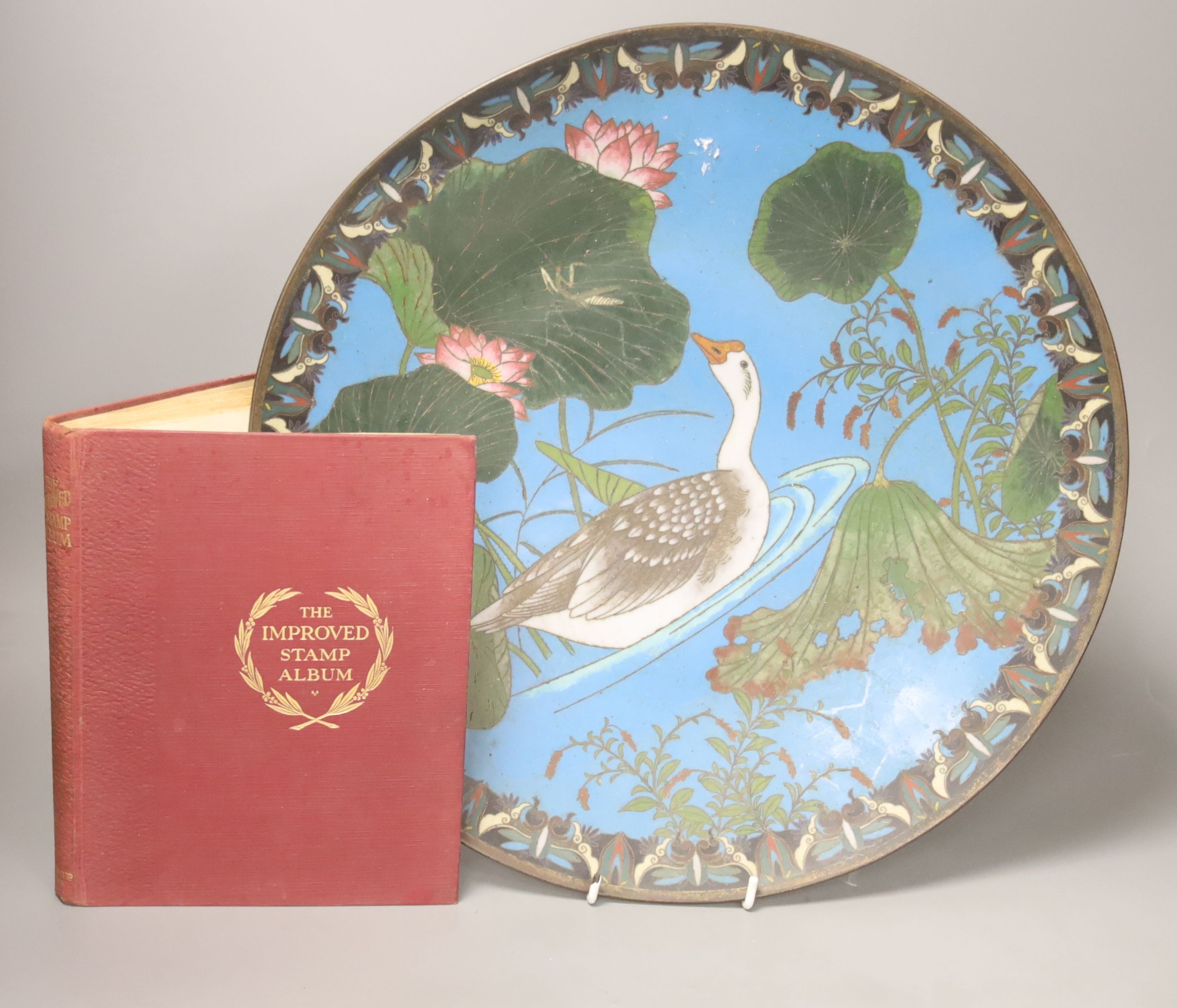 A Japanese cloisonne charger, diameter 39cm, together with a stamp album